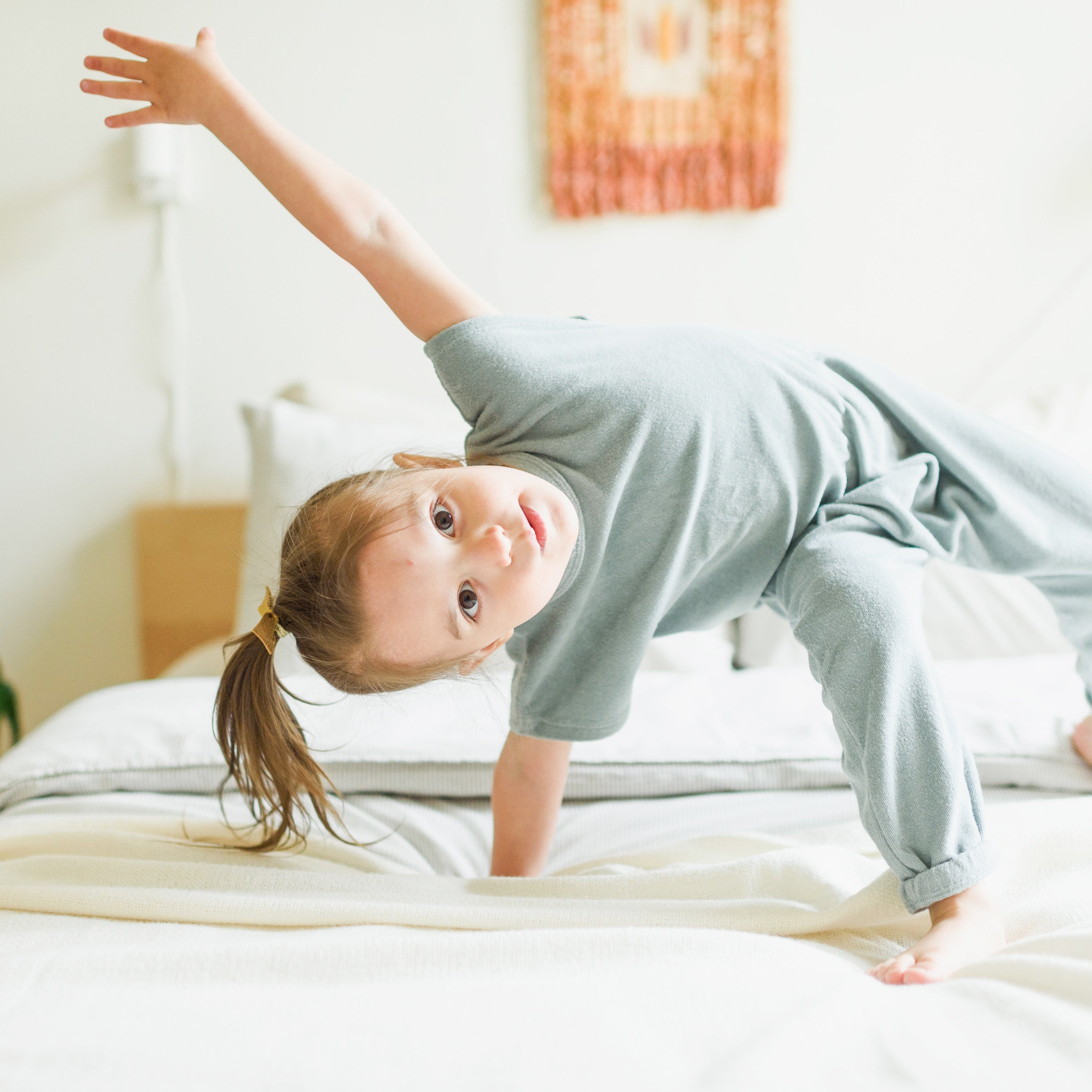 Child Playing on a Clean bed after it has been cleaned and washed with AspenClean green cleaners