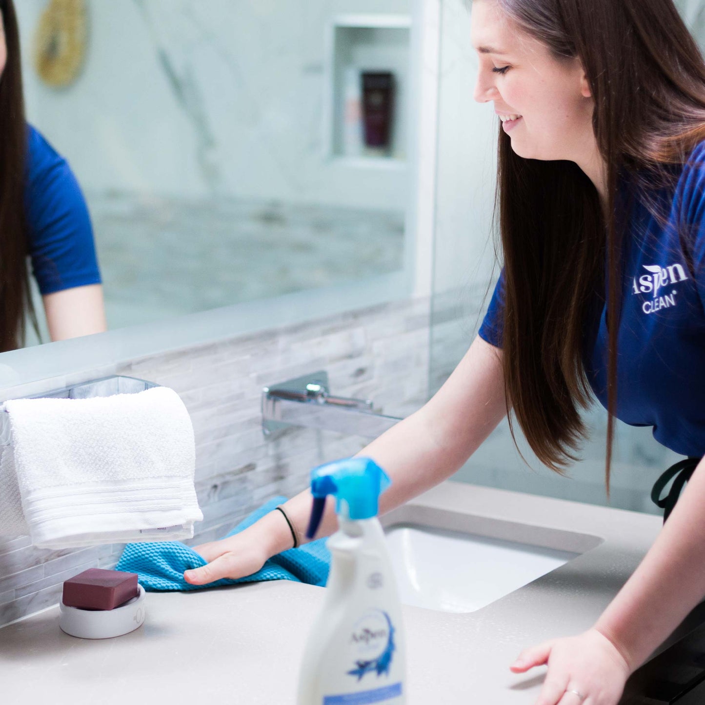 A person using Bathroom Microfiber Cloth to clean a faucet