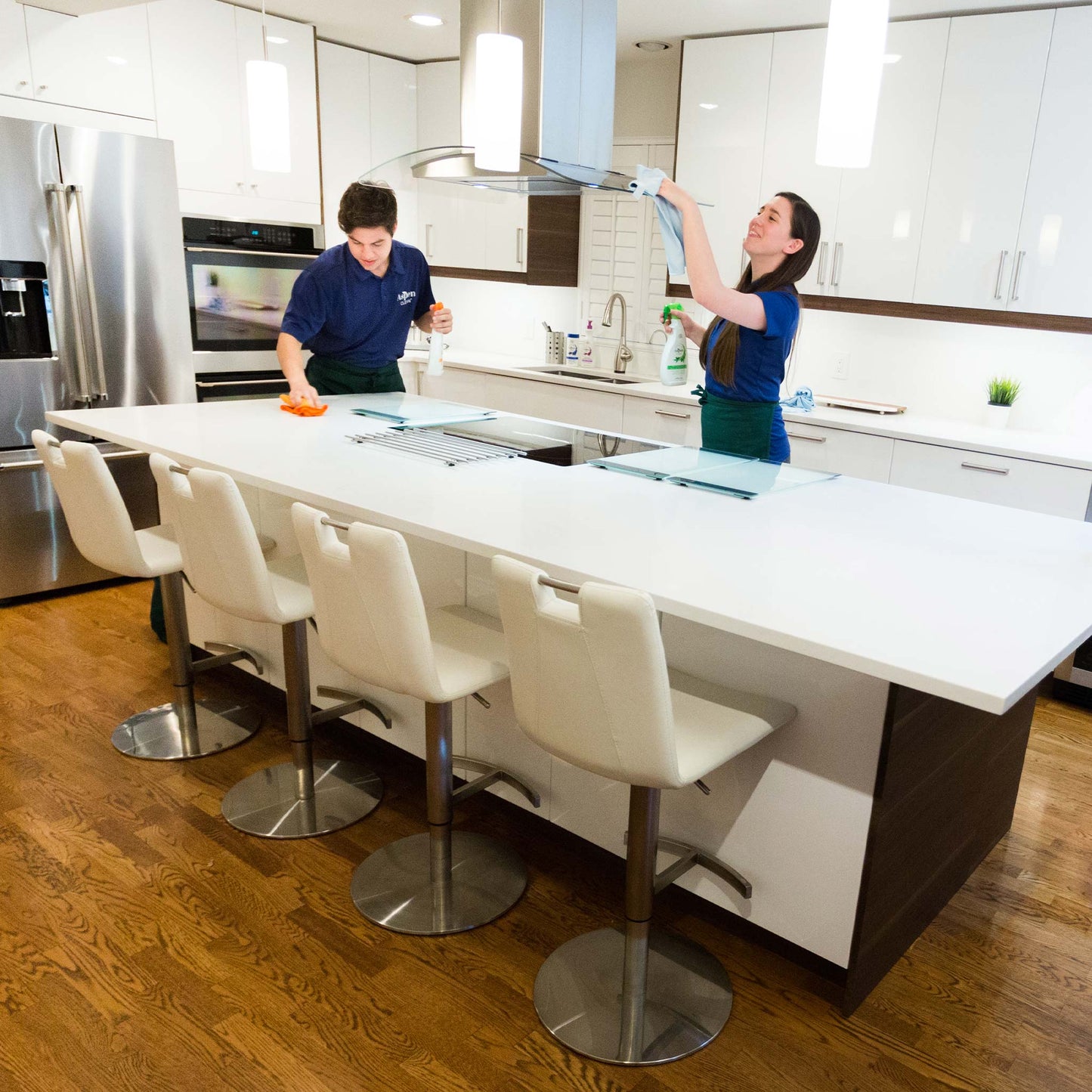 Two AspenClean cleaners cleaning the kitchen area using House Cleaning Kit