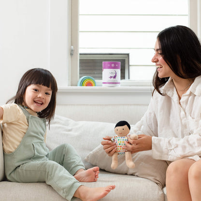 A mom with her baby and AspenClean Eco-Mom Cleaning Kit