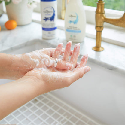 Lady washing the dishes using AspenClean Hypoallergenic Cleaning Kit