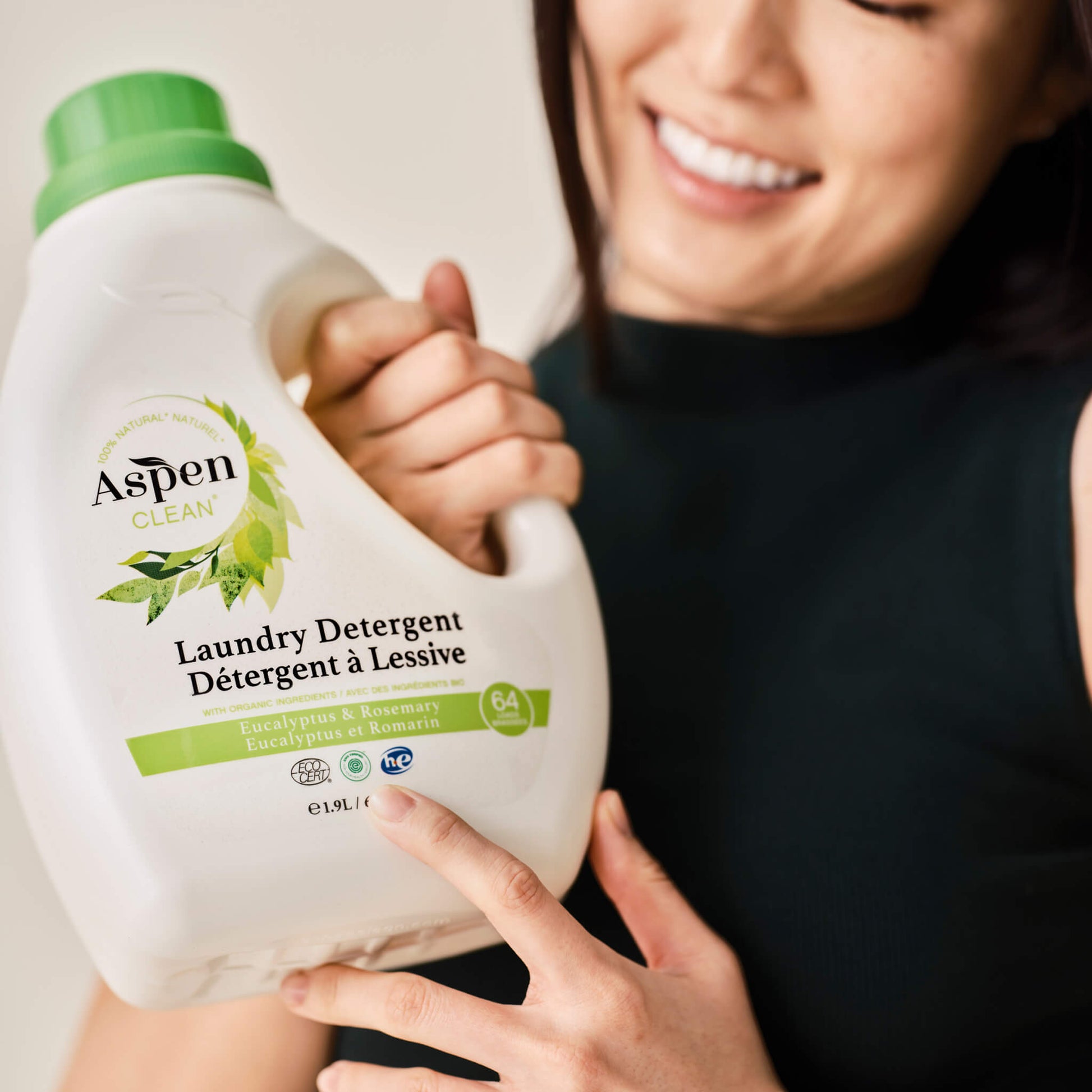 Lady is holding AspenClean Laundry Detergent Eucalyptus