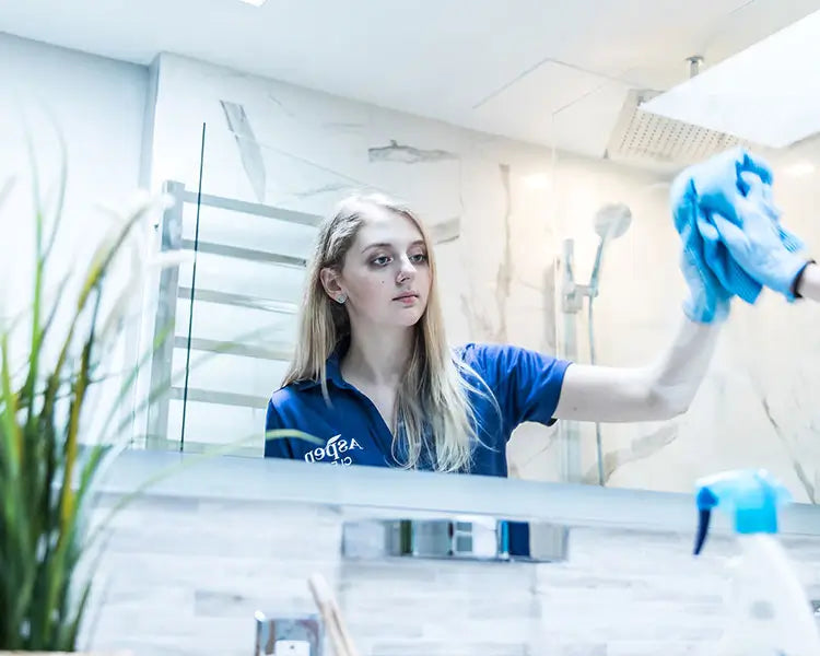 AspenClean team member is cleaning a bathroom