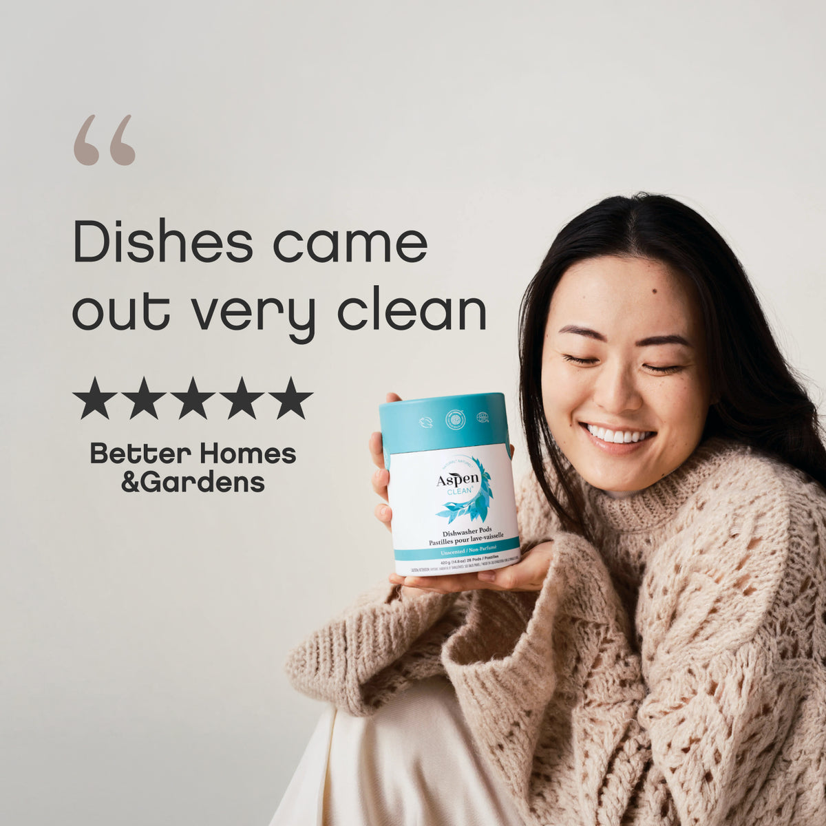 Lady is holding AspenClean Dishwasher pods.