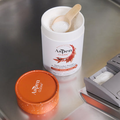 AspenClean dishwasher powder container with a wooden scoop.