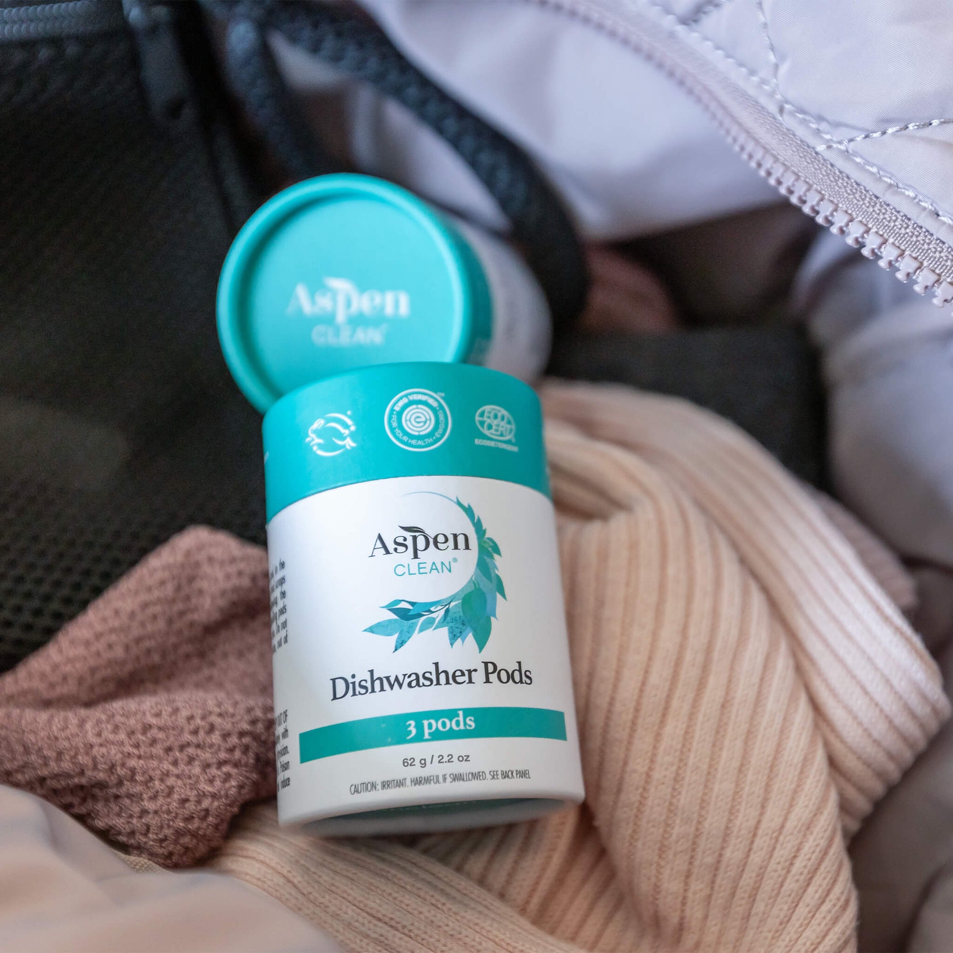 AspenClean dishwasher pods container inside a bag with clothes.