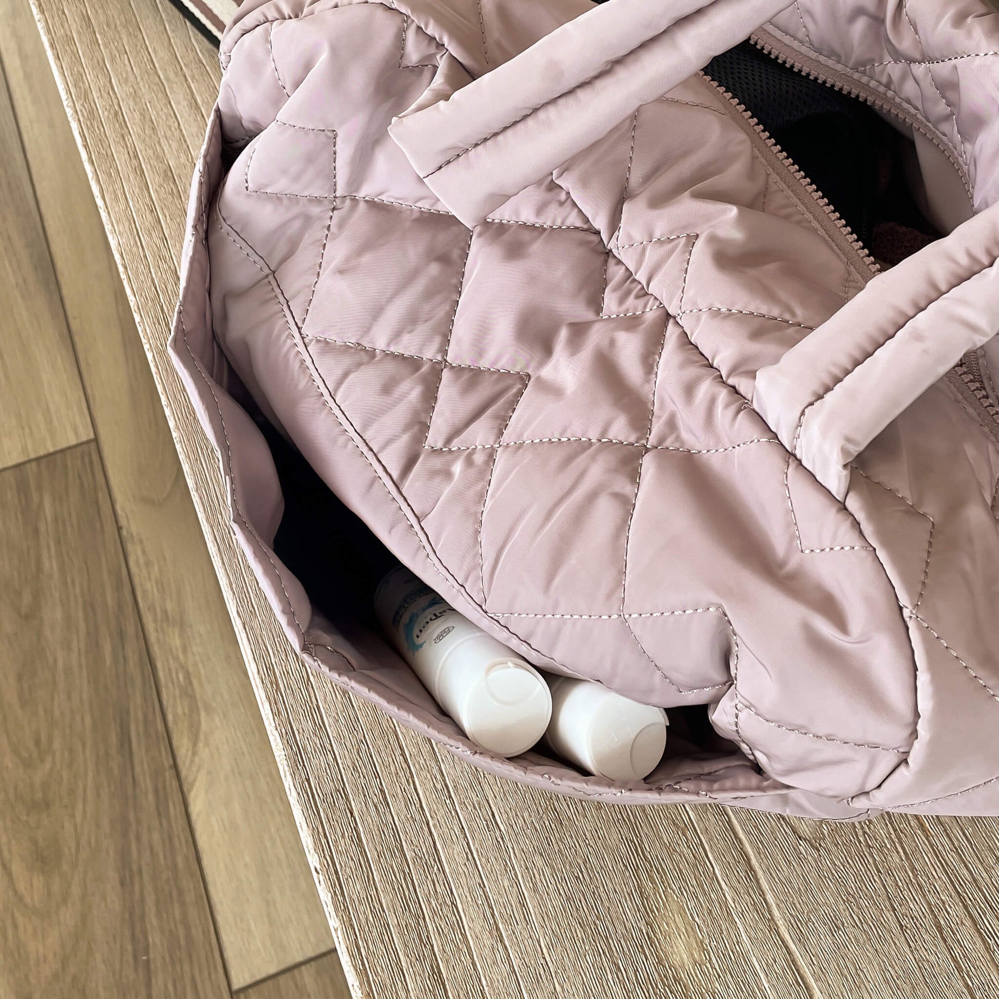 AspenClean laundry detergent travel size in side pocket of the travel bag